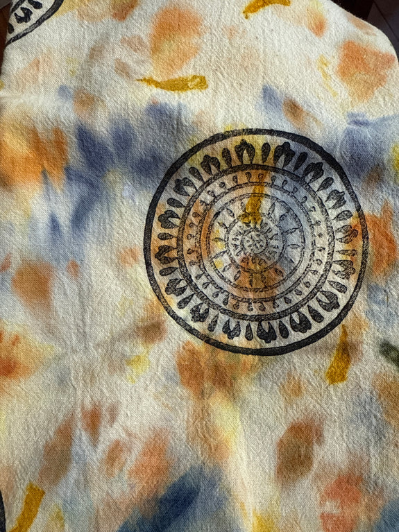 Floral patterned tea towel with circular designs